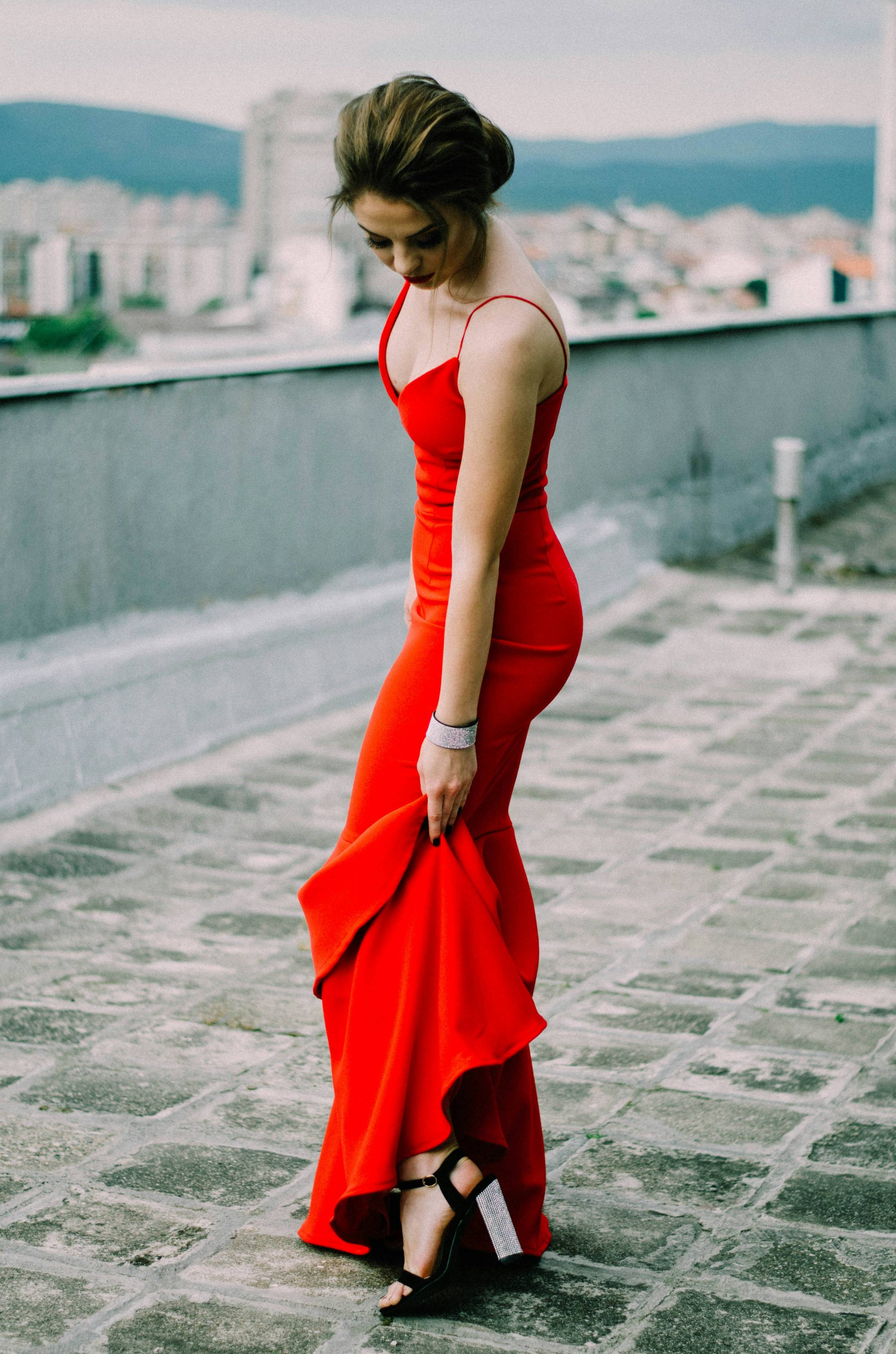 woman wearing red spaghetti strap dress