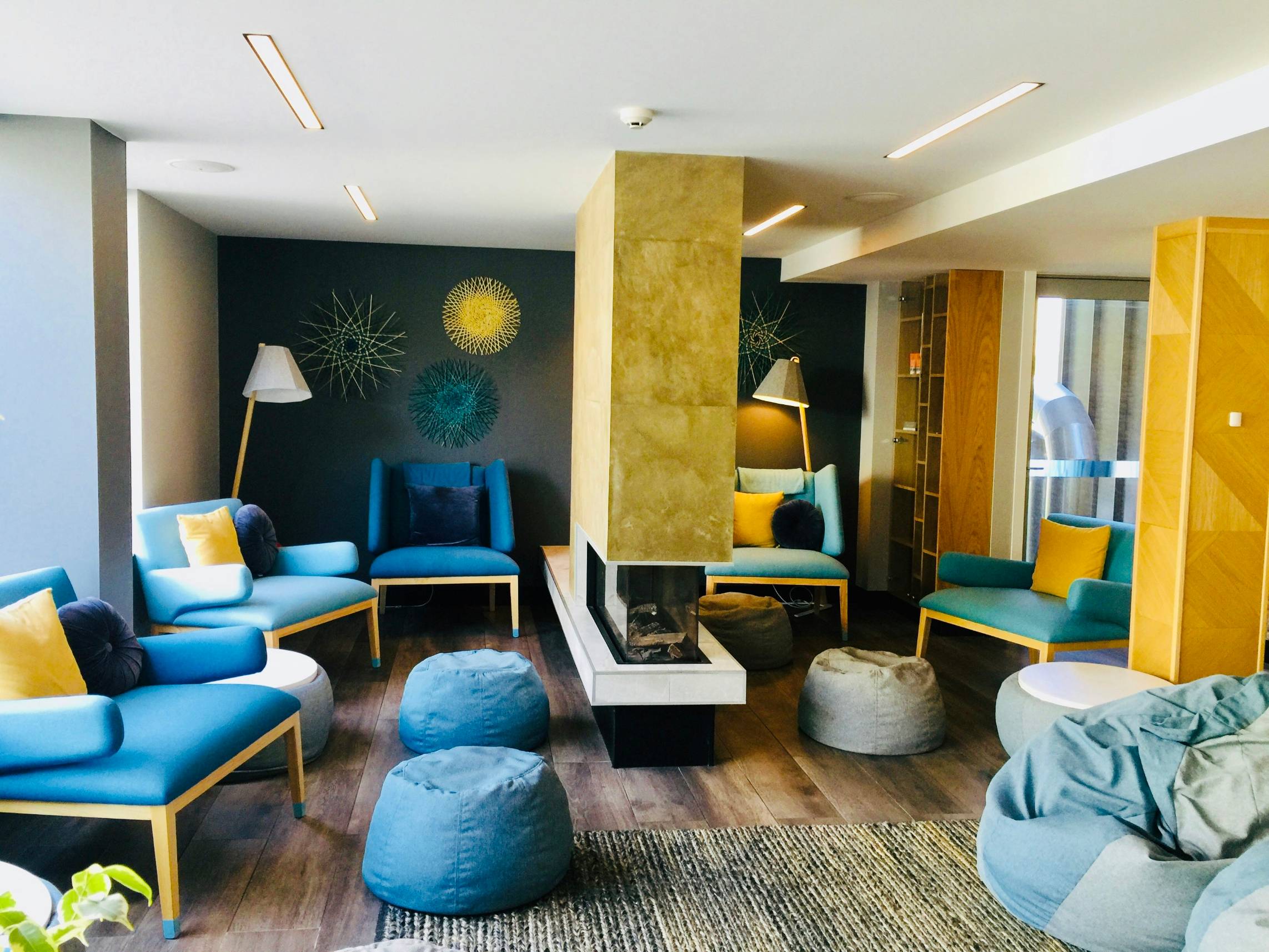 a living room filled with blue and yellow furniture