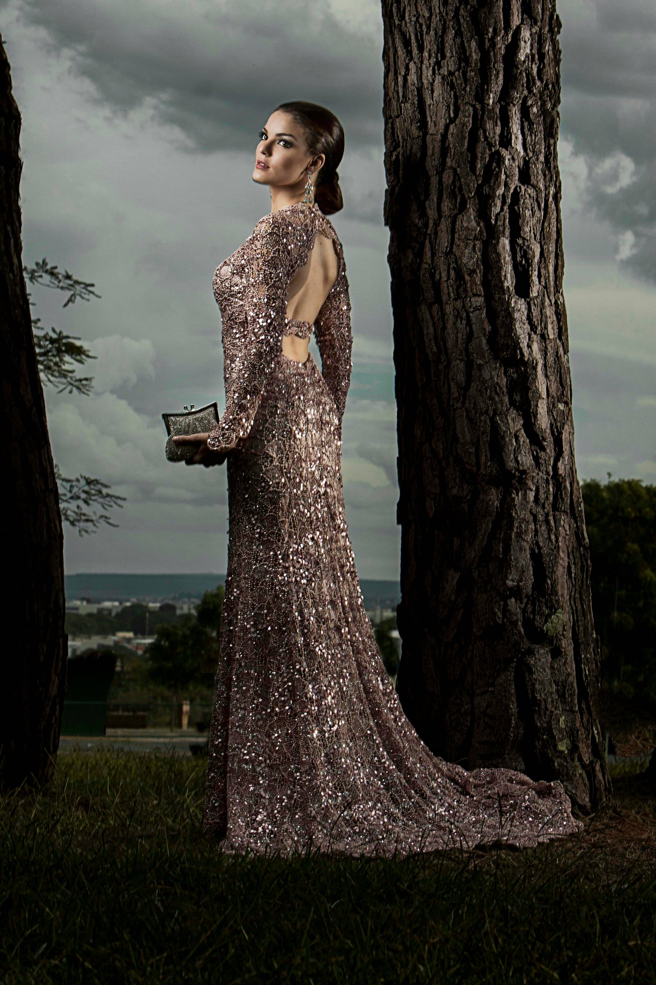 woman in gray glitter gown standing beside tree